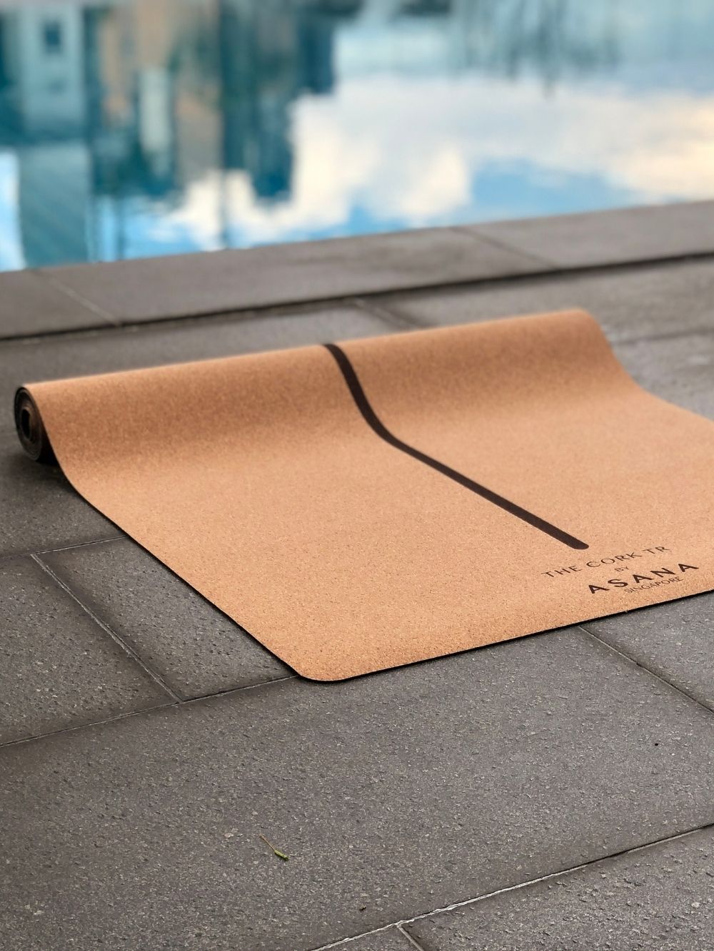 Cork TR Mat by Asana Singapore next to a swimming pool in Singapore