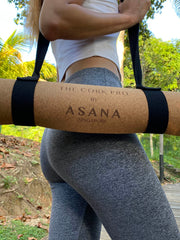 Slim Asian Woman Carrying The Cork Pro Ultimate Workout Mat With Strap by Asana Singapore