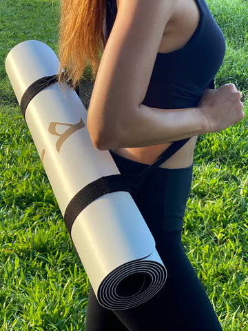 Fit Woman Carrying The Sphinx Pro Ultimate Workout Mat With Strap by Asana Singapore